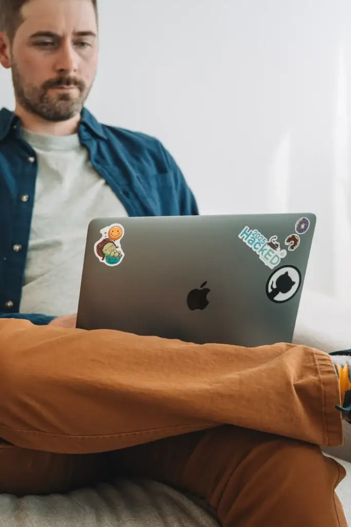 a man sitting with his computer
